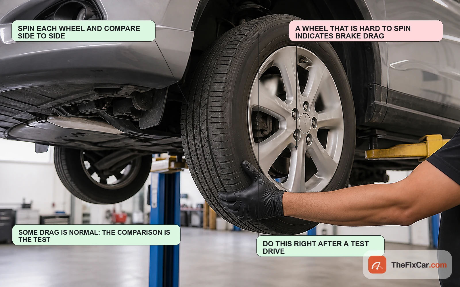 Technician spinning a front wheel by hand on a lift to compare brake drag against the opposite side