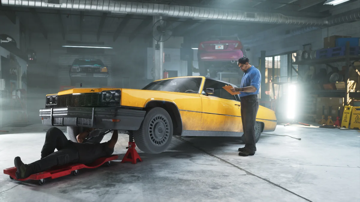 A car raised on jack stands inside the Rideout Customs workshop