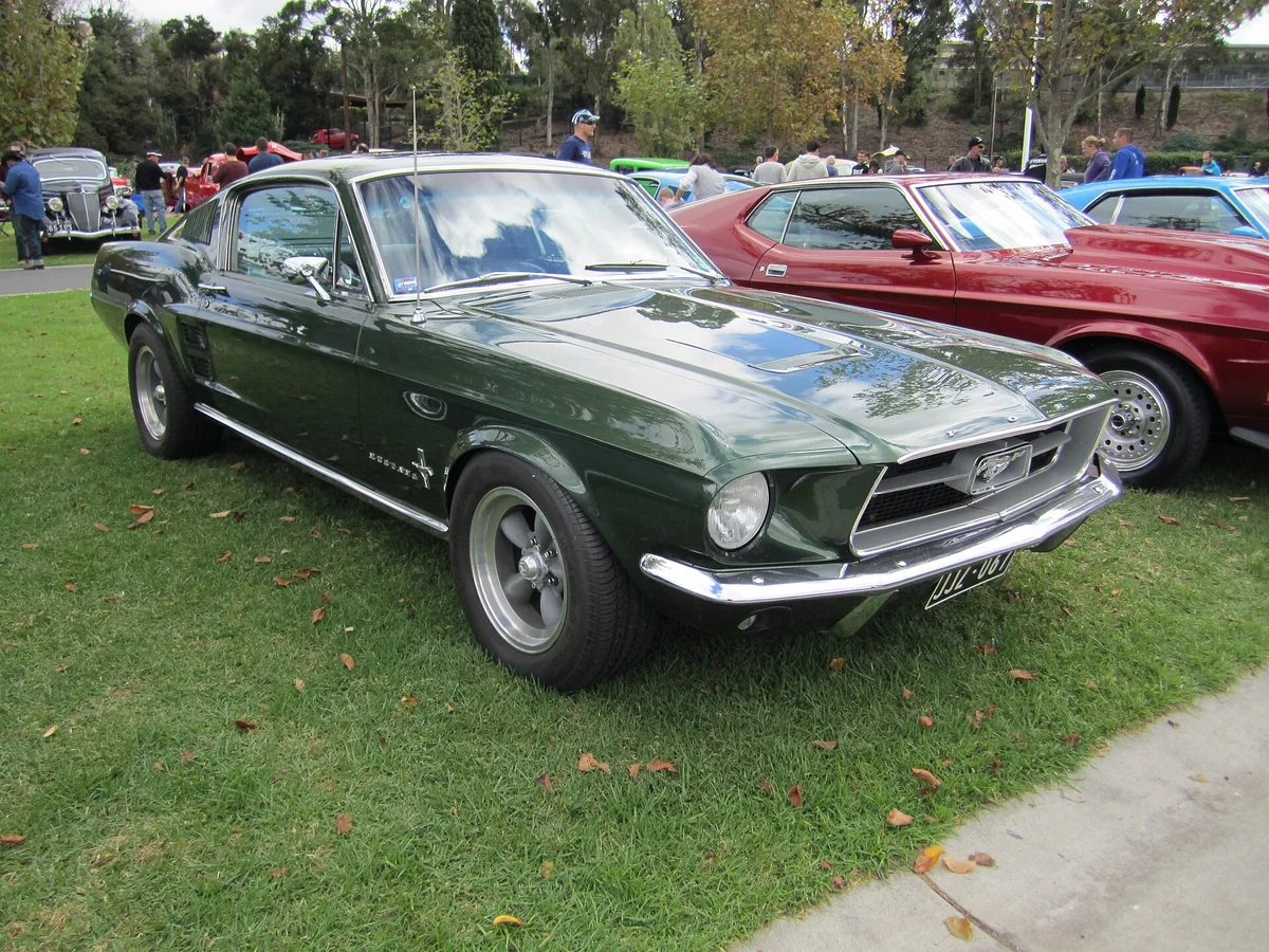 A dark green 1967 Ford Mustang fastback